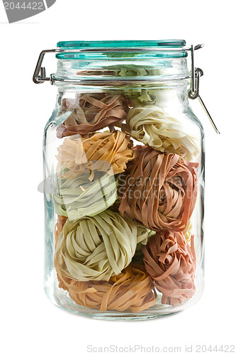 Image of colorful pasta tagliatelle in glass jar