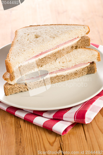 Image of ham sandwich on checkered napkin