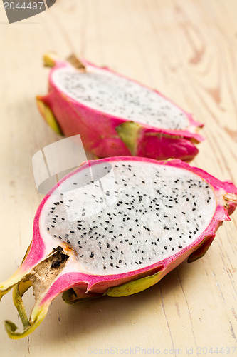 Image of pink pitahaya on wooden table