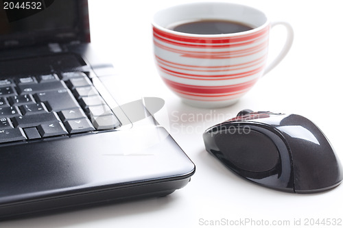 Image of computer mouse and coffee cup