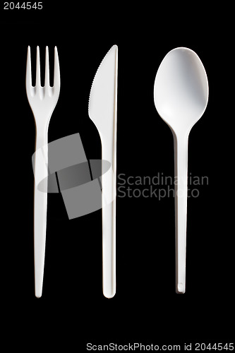 Image of plastic cutlery on black background
