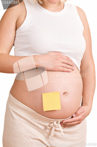 Image of pregnant women with notepaper on her belly