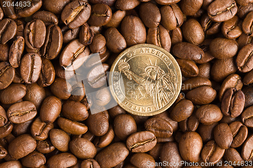 Image of coin on coffee beans background