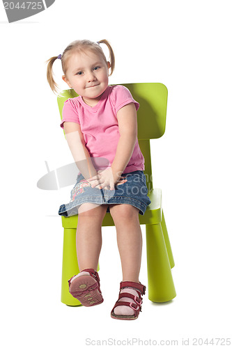 Image of little child sits on a chair