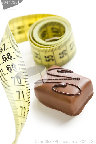 Image of chocolate praline with measuring tape