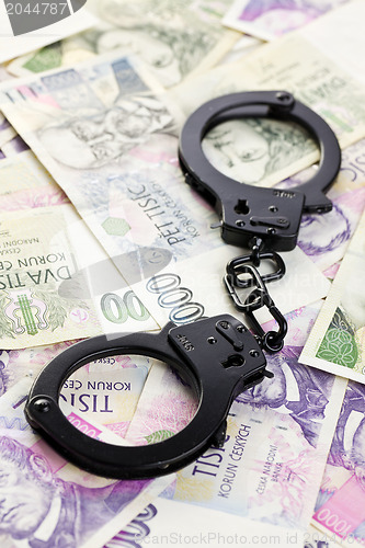 Image of handcuffs on czech money