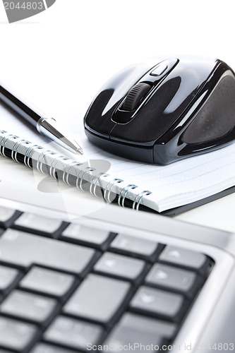 Image of computer mouse and notebook with pen