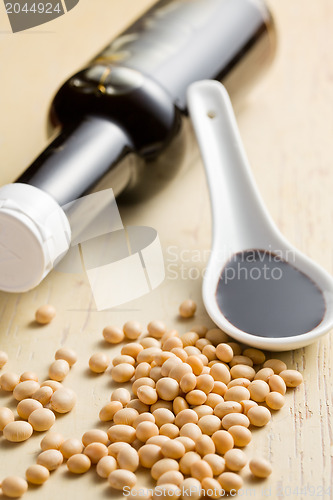 Image of soy sauce in ceramic spoon