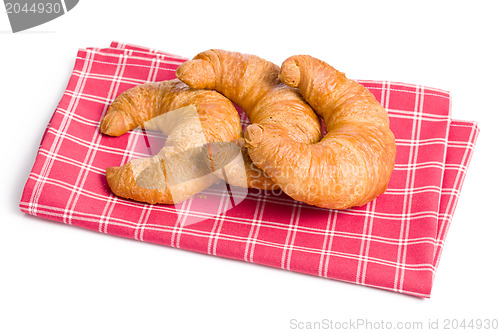 Image of fresh croissants on checkered napkin