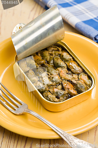 Image of smoked mussels in opened tin can