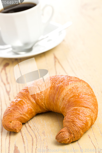 Image of fresh croissant on wooden table