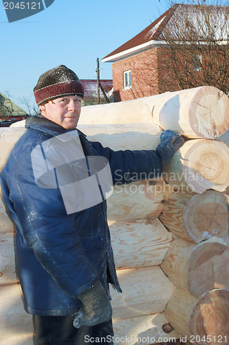 Image of Carpenter produces log-house