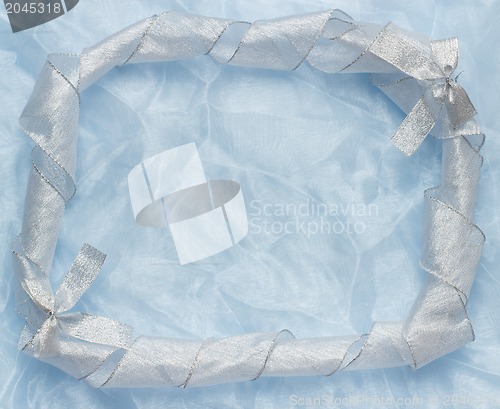 Image of Christmas background with blue ornament and curled ribbon