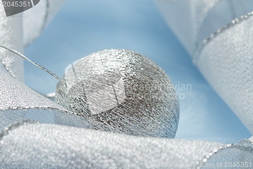 Image of Christmas background with blue ornament and curled ribbon