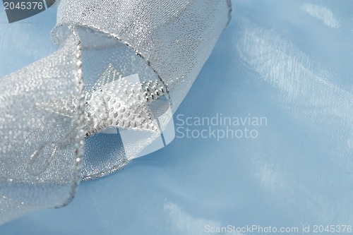 Image of Christmas background with blue ornament and curled ribbon