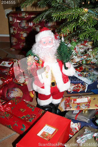 Image of Santa Claus standing together with Christmas presents