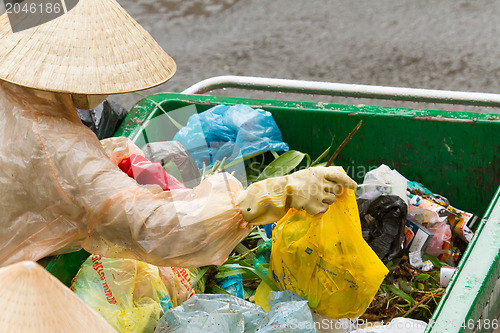 Image of DA LAT, VIETNAM - 28 JULY 2012: Government worker separates the 