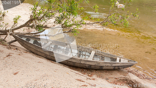 Image of Small rowing boat on the shore of a small river