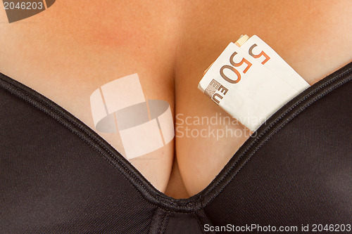 Image of Concept - woman with cash in a bra