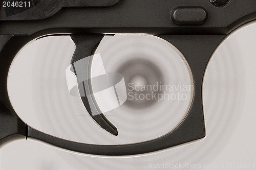 Image of The trigger of a handgun with a shooting target 