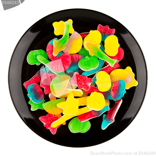 Image of Colorful candies in many different shapes isolated on a black pl