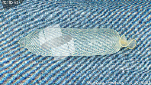 Image of Condom filled with water on jeans 