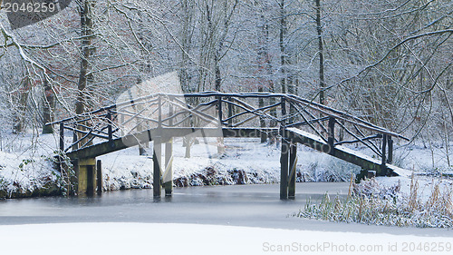 Image of Wooden bridge covered in snow