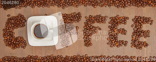Image of The word Coffee spelled with hundreds of coffee beans and one cu