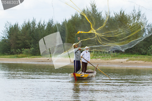 Image of Fisherman is fishing with a large net in a river in Vietnam
