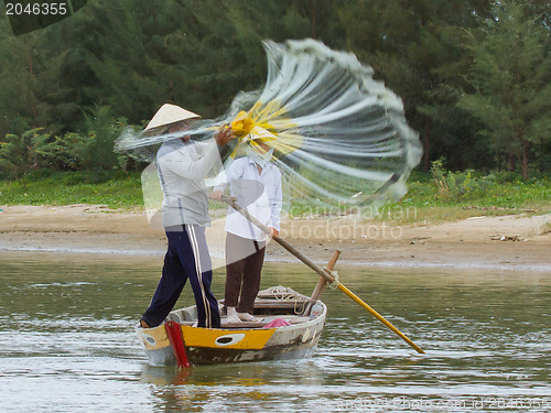 Image of Fisherman is fishing with a large net in a river in Vietnam