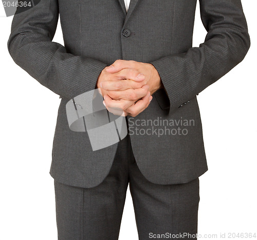 Image of Business man in grey suit praying