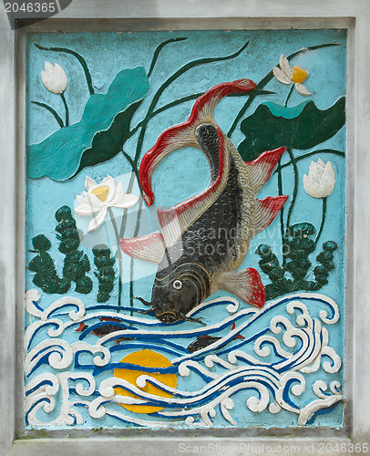 Image of HANOI, VIETNAM, 8 AUGUST 2012; Ancient drawing of a fish at the 