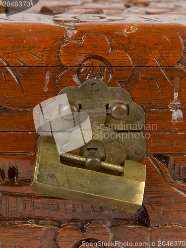 Image of Old padlock on a wooden chest made in Suriname