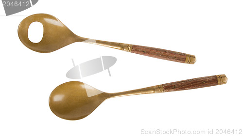 Image of Old brass serving spoons isolated