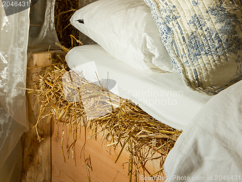 Image of Bed on top of a haystac