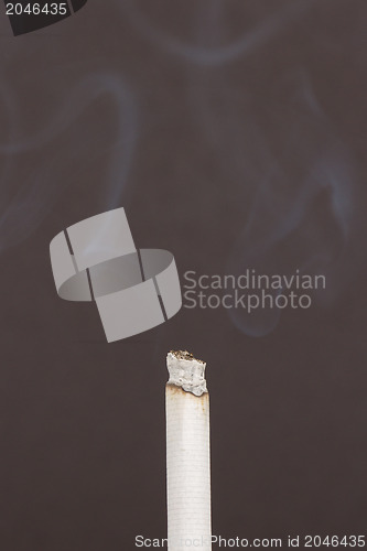 Image of Burning cigarette with smoke