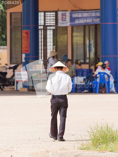 Image of HUE, VIETNAM, 5 AUGUST 2012; Man with a traditional leaf had in 