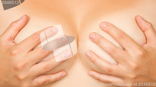 Image of Hands covering breasts