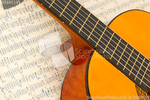 Image of Old music sheet and a guitar