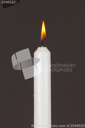 Image of Burning white candle, isolated