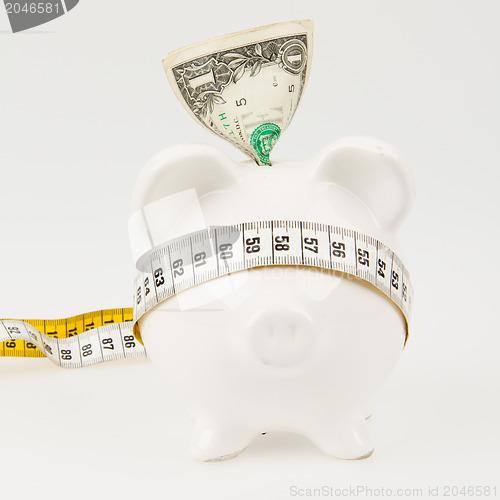 Image of White piggy bank with measuring tape