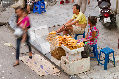 Image of HANOI, VIETNAM, 8 AUGUST 2012; Vietnamese street vendor selling 