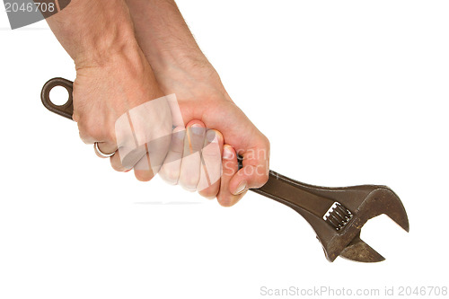 Image of Old rusted adjustable vector wrench in a hand