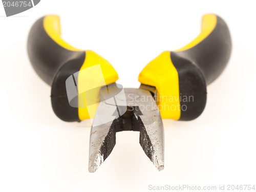 Image of Used yellow tool pliers isolated, rust and dust 