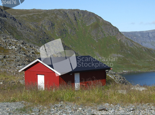 Image of Small red house in mountains