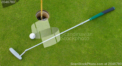 Image of Golf hole with ball and putt