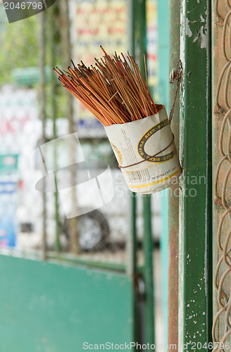 Image of Incence sticks in an cut beer can