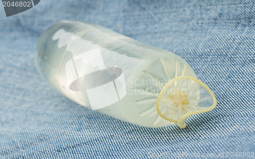 Image of Condom filled with water on jeans 