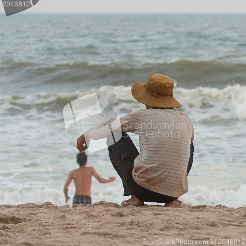 Image of Man sitting on the beach at the south chinese sea 