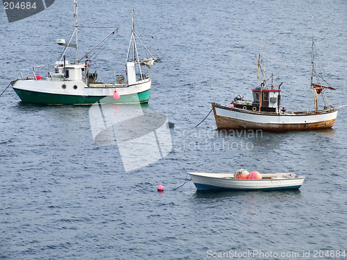 Image of Two fishing ships and a boat on anchor